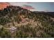 Luxury home nestled in the mountains at sunset at 3864 Valley Dr, Evergreen, CO 80439