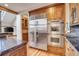 Island kitchen with stainless steel appliances and rustic wood cabinets at 3864 Valley Dr, Evergreen, CO 80439