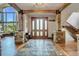Bright entryway with hardwood floors, stone accents, and a view of the living room at 3864 Valley Dr, Evergreen, CO 80439