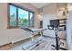 Home exercise room with stationary bike and adjustable exam table at 3864 Valley Dr, Evergreen, CO 80439