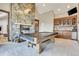Game room with pool table, stone fireplace, and wet bar at 3864 Valley Dr, Evergreen, CO 80439