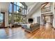 Open living area with hardwood floors and a view from expansive windows at 3864 Valley Dr, Evergreen, CO 80439