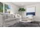 Living area with white sofa, armchair, and coffee table at 1098 S Bryant St, Denver, CO 80219