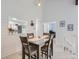 Charming dining area with glass-top table and kitchen pass-through at 7640 S Monaco Cir, Centennial, CO 80112