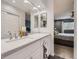 Bathroom with double vanity and view into bedroom at 7640 S Monaco Cir, Centennial, CO 80112