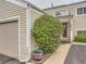Townhouse featuring a private entrance and mature shrubbery at 7640 S Monaco Cir, Centennial, CO 80112