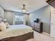 Bright bedroom with a bed, dresser and ceiling fan at 7640 S Monaco Cir, Centennial, CO 80112