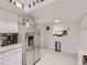 Modern kitchen with white cabinets, stainless steel appliances, and breakfast bar at 7640 S Monaco Cir, Centennial, CO 80112