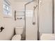 Clean bathroom with shower, toilet, and glass enclosure at 4411-4415 Grant St, Denver, CO 80216