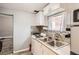 Galley kitchen with white cabinets and four-burner stove at 4411-4415 Grant St, Denver, CO 80216