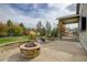 Stone patio with fire pit and built-in seating at 7030 S Buchanan St, Aurora, CO 80016