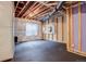 Unfinished basement area with window and flooring at 7030 S Buchanan St, Aurora, CO 80016