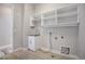 Laundry room with white cabinets, a sink, and overhead shelving at 7030 S Buchanan St, Aurora, CO 80016