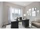 Home office with large window, hardwood floors, and built-in desk at 7030 S Buchanan St, Aurora, CO 80016