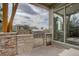 Outdoor kitchen with built-in grill and refrigerator at 7030 S Buchanan St, Aurora, CO 80016