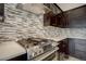 Stainless steel gas range with modern backsplash in a contemporary kitchen setting at 7030 S Buchanan St, Aurora, CO 80016