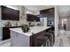 Modern kitchen with dark cabinetry, white countertops, and stainless steel appliances at 7030 S Buchanan St, Aurora, CO 80016
