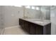 Modern bathroom with double vanity and large shower at 7030 S Buchanan St, Aurora, CO 80016