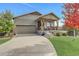 House exterior features a two-car garage and a covered porch at 7030 S Buchanan St, Aurora, CO 80016