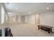 Spacious finished basement with neutral carpeting, projection screen, and plenty of room for entertainment at 7030 S Buchanan St, Aurora, CO 80016