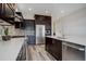 Modern kitchen with stainless steel appliances and dark brown cabinets at 7030 S Buchanan St, Aurora, CO 80016