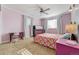 Bright bedroom with pink walls, a bed, and desk at 6390 S Quay Ct, Littleton, CO 80123