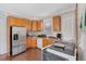 Efficient kitchen with wood cabinets, stainless steel appliances, and wood floors at 1544 N Downing St, Denver, CO 80218