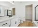 Modern bathroom with white vanity, soaking tub, and walk-in shower at 42986 Colonial Trl, Elizabeth, CO 80107