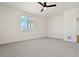 Spacious bedroom with grey carpet, window, and ceiling fan at 42986 Colonial Trl, Elizabeth, CO 80107