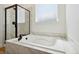 Bathroom with soaking tub, walk-in shower, and marble accents at 42986 Colonial Trl, Elizabeth, CO 80107