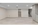 Spacious finished basement with gray flooring and access to other rooms at 2230 Jamaica St, Aurora, CO 80010