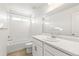 Clean bathroom with white tile, a vanity, and a bathtub at 1562 Farmstead St, Brighton, CO 80601