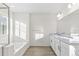 Spacious primary bathroom with double vanity, soaking tub, and glass shower at 1562 Farmstead St, Brighton, CO 80601