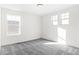 Empty bedroom with gray carpeting and multiple windows at 1562 Farmstead St, Brighton, CO 80601