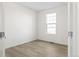 Empty bedroom with wood-look flooring and one window at 1562 Farmstead St, Brighton, CO 80601