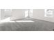 Large bedroom with gray carpeting and plenty of natural light from multiple windows at 1562 Farmstead St, Brighton, CO 80601