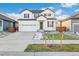 Charming two-story home with white siding, black trim, and a welcoming front porch at 1562 Farmstead St, Brighton, CO 80601