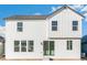 Modern farmhouse exterior with white siding and a sliding glass door at 1562 Farmstead St, Brighton, CO 80601