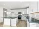 Modern kitchen featuring white shaker cabinets, dark gray countertops, and stainless steel appliances at 1562 Farmstead St, Brighton, CO 80601