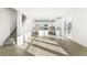 Open concept kitchen and living area with wood-look flooring and ample natural light at 1562 Farmstead St, Brighton, CO 80601