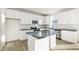 Stylish kitchen with white cabinetry, dark countertops, and stainless steel appliances at 1562 Farmstead St, Brighton, CO 80601