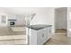 View of the kitchen and living area with a fireplace and large windows at 1562 Farmstead St, Brighton, CO 80601