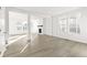 Spacious living room with a cozy fireplace, large windows, and wood-look flooring at 1562 Farmstead St, Brighton, CO 80601