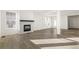 Cozy living room with a fireplace and large windows, perfect for relaxation at 1562 Farmstead St, Brighton, CO 80601