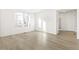 Bright living room with large windows, wood-look flooring, and a view of the entryway at 1562 Farmstead St, Brighton, CO 80601
