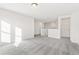 Carpeted loft area with doors leading to bedrooms and a view of the staircase at 1562 Farmstead St, Brighton, CO 80601