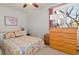 Cozy bedroom with wood dresser and floral bedding at 750 S Clinton St # 12D, Denver, CO 80247