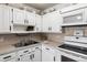 Bright white kitchen with ample cabinetry, built-in microwave, and modern appliances at 750 S Clinton St # 12D, Denver, CO 80247