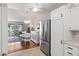 Modern kitchen with stainless steel refrigerator and white cabinetry at 750 S Clinton St # 12D, Denver, CO 80247