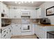 Bright white kitchen with ample cabinetry, built-in microwave, and modern appliances at 750 S Clinton St # 12D, Denver, CO 80247